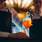bartender pouring a cocktail