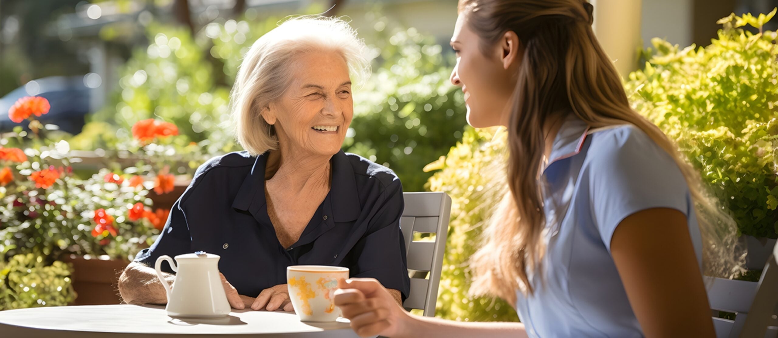 Two ladies, one older, sitting down for tea