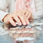 hands of an elderly person with a puzzle