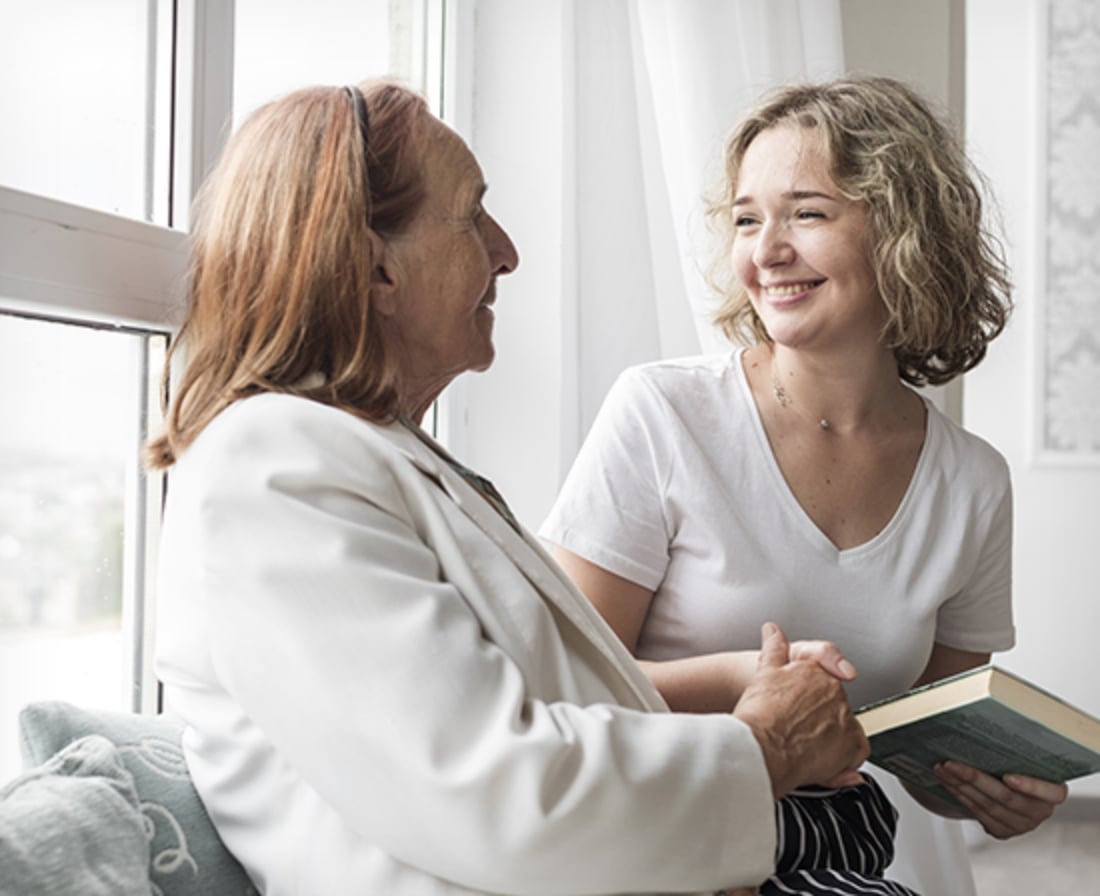 Careworker reading to a resident