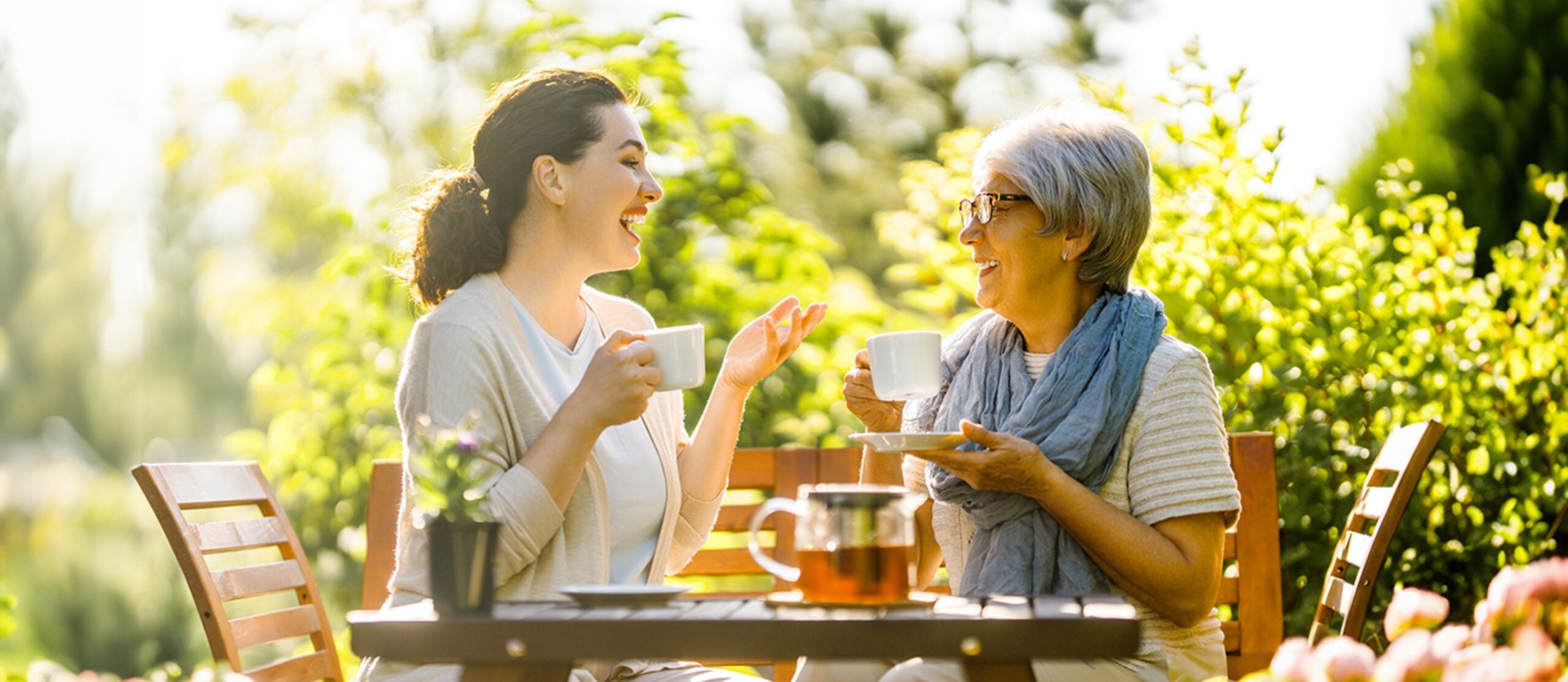 Two women sitting at a table enjoying tea