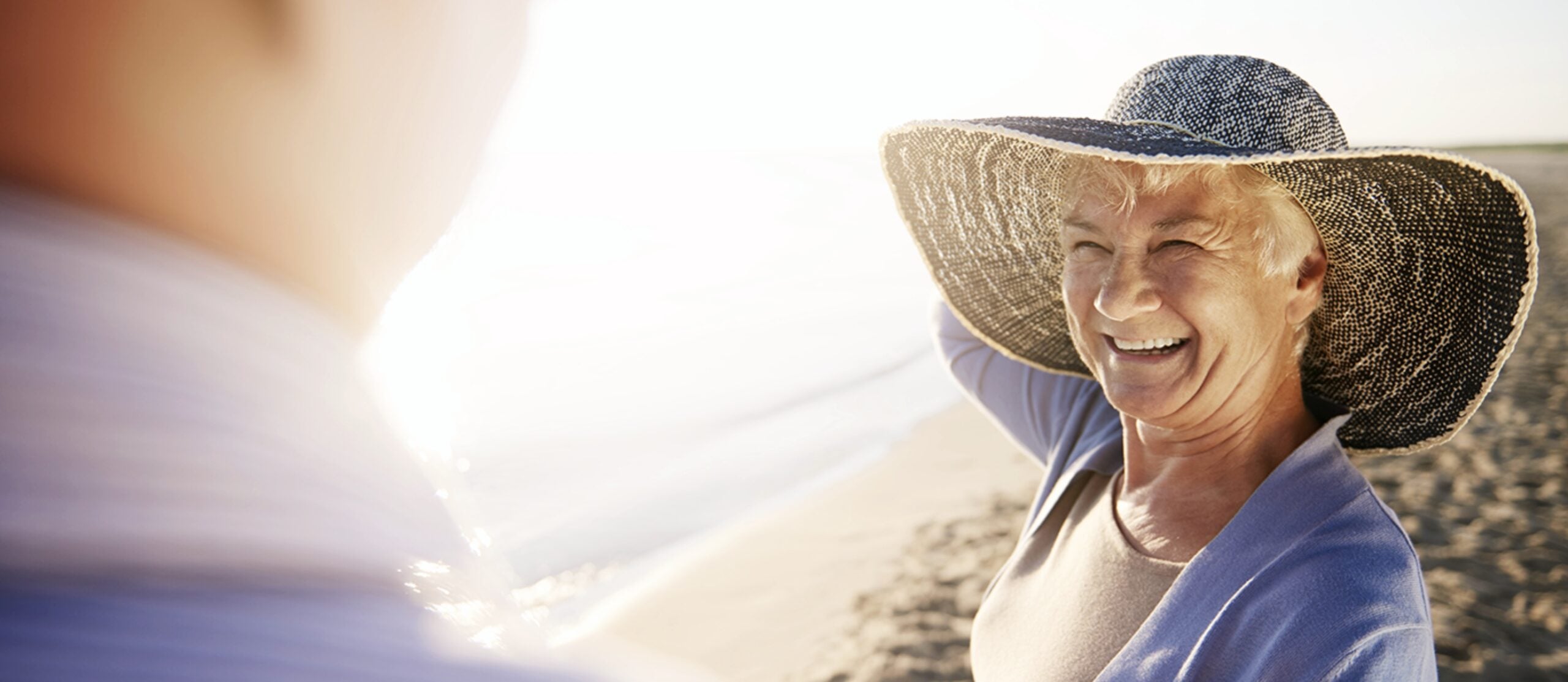 residents smiling while enjoying a walk on the beach in San Clemente