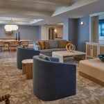 This is a photo of The Seville's memory care common areas, which include a TV, comfortable seating, and modern decorations.