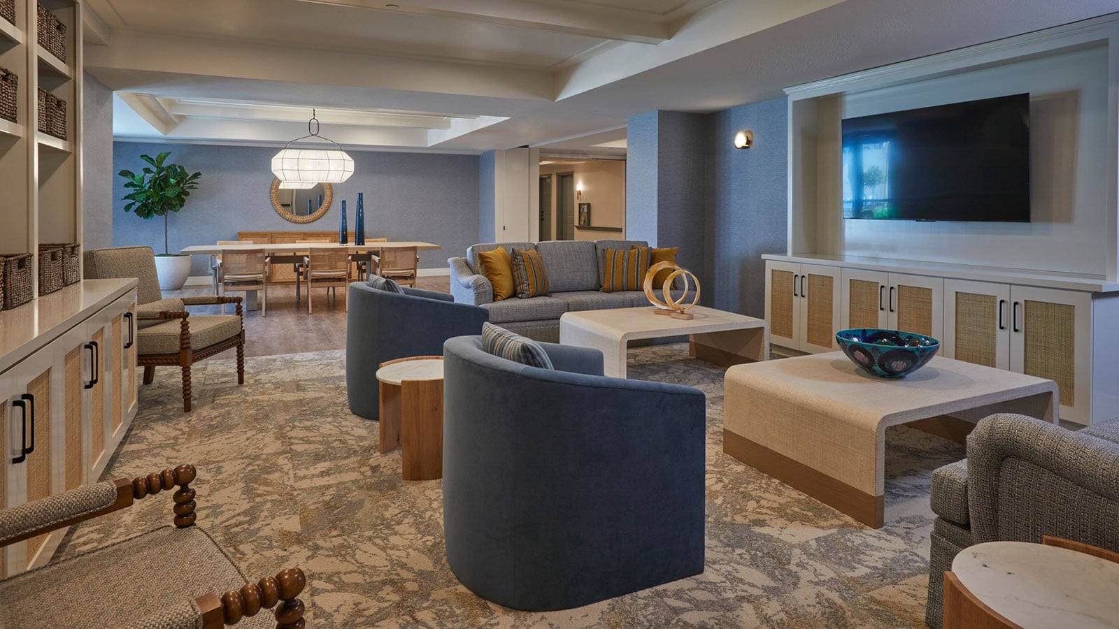 This is a photo of The Seville's memory care common areas, which include a TV, comfortable seating, and modern decorations.
