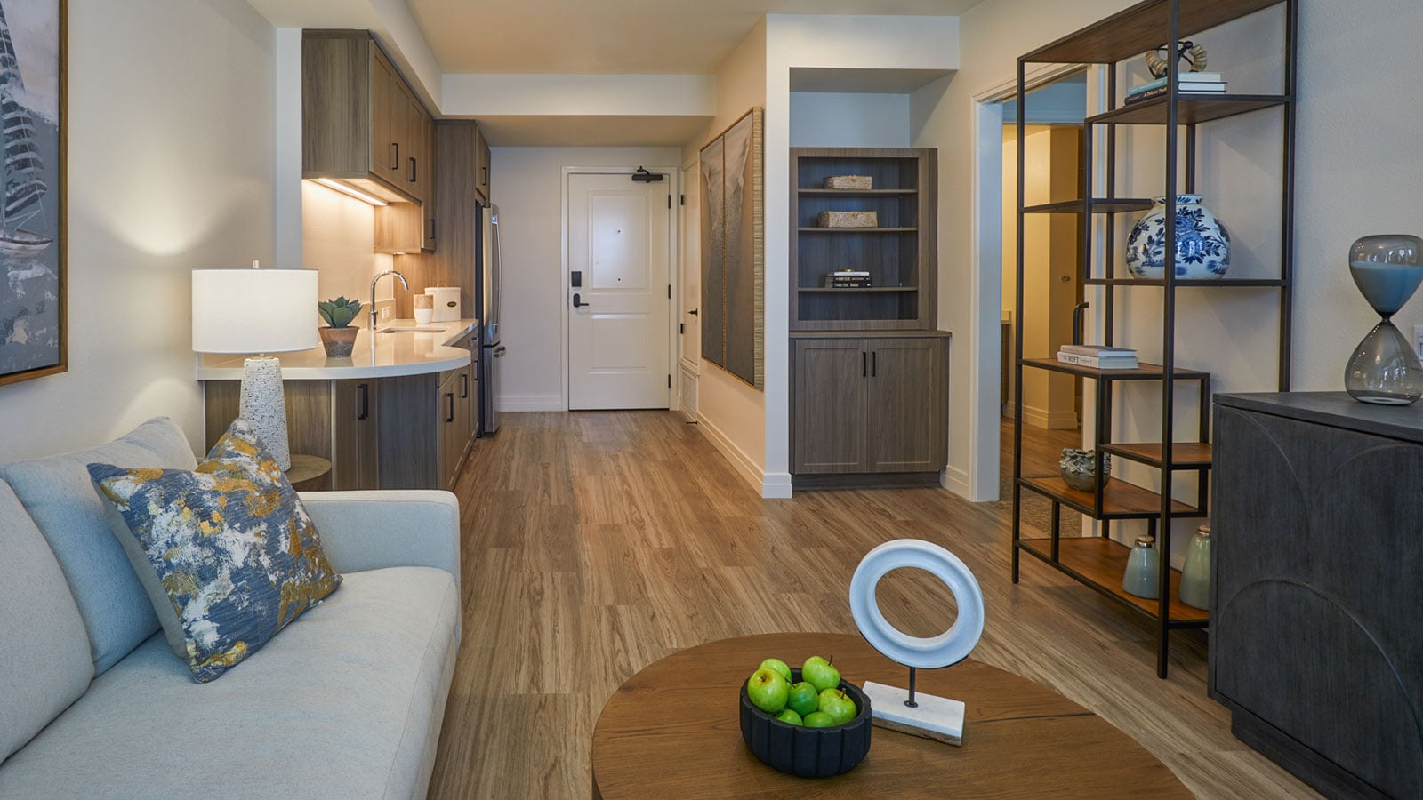 This is a photo of The Seville's assisted living apartment model, the San Onofre. The apartment is staged with a couch and various other items of furniture.